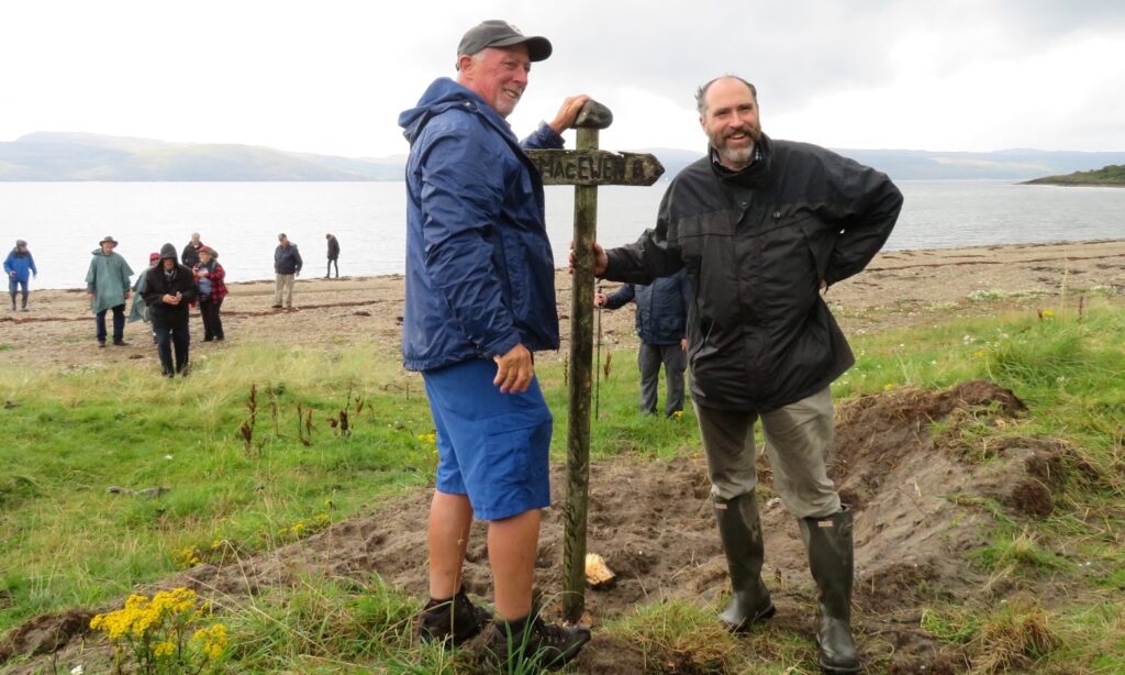 Clan Ewing fixes the sign pointing to our ancient castle